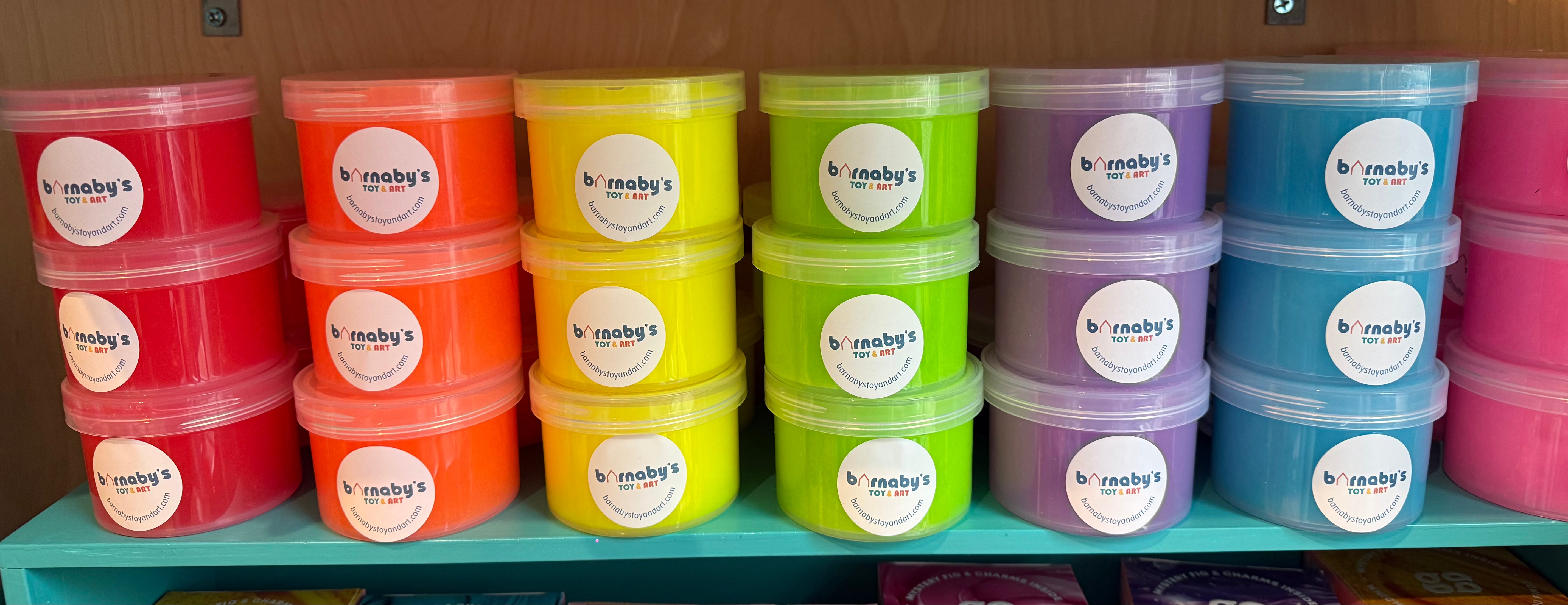 Stacks of colorful containers with labels on a shelf